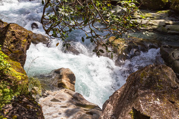 Fiordland National Park. A stormy stream disappearing into a funnel. Funnel Chasm. Stream among stones. South Island, New Zealand.