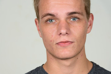 Fototapeta premium Face of young handsome man with blond hair