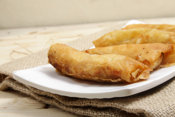 Group of rissoles on a white square plate