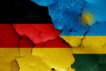 flags of Germany and Rwanda painted on cracked wall