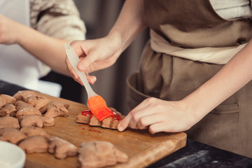 Obraz na płótnie Canvas Close up of cookies baking. Little kids hands
