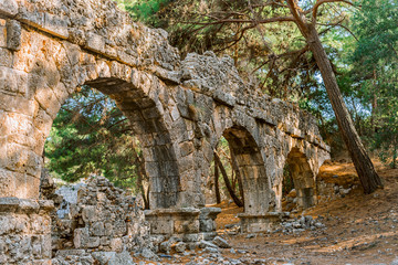  Ruins of the aqueduct in the ancient Phaselis city, Turkey. Travel and architecture.