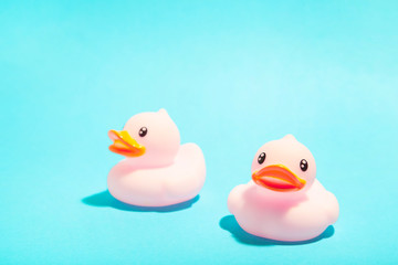 Pink rubber ducks organized on blue background.