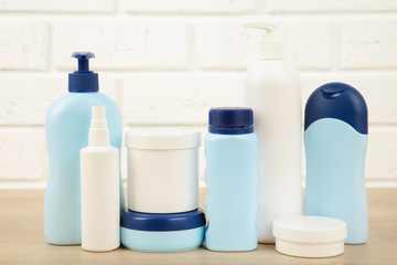 Different cosmetic bottles on white background. Top view