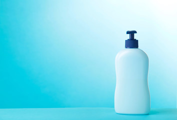 Blue tube of cosmetic on blue background