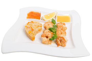 Fried large shrimps with different sauces and basil.