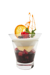 Milk mousse with fruit jam and slice of orange.