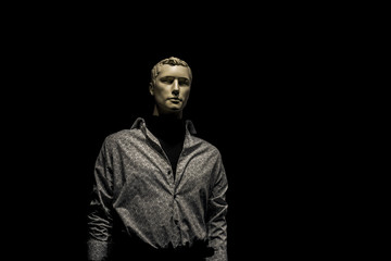 mannequin man in shirt isolated on black background