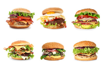 Set of different delicious burgers on white background