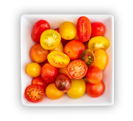 Bowl of colorful cherry tomatoes (red, garnet and yellow), fresh and raw. Cut and whole. Cenital plane (top view). With water drops, Isolated on white background.
