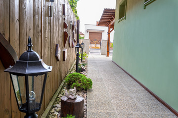 Fototapeta na wymiar Entrence pavement to the family house with lamps