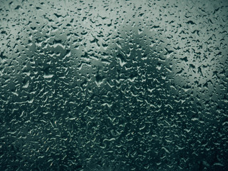 Rainy background, rain water drops on the window or in shower stall, autumn season backdrop, abstract textured wallpaper.