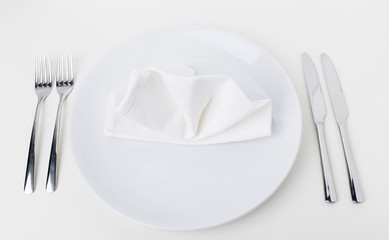 Empty white plate and cotton white napkin.