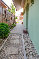 Fototapeta na wymiar Entrence pavement to the family house with lamps