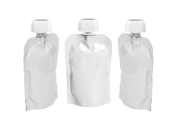 three White empty plastic doy pack with spout and round lid from different angles, for baby food, fruit puree, snack on the go, isolated on a white background