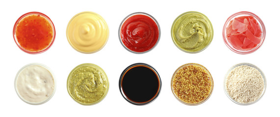 Set of different delicious sauces and condiments on white background, top view. Banner design