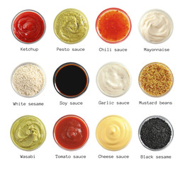 Set of different delicious sauces and condiments on white background, top view