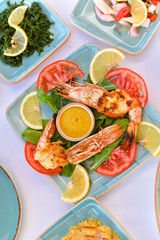 appetizers with yogurt, tomatoes, cheese, lemon, greens, mussels, olives, snacks on white background, ready for service, should be used as background.