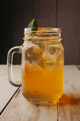 cocktail with ice in a bar on a wooden dlsky background