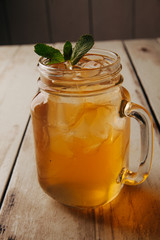 cocktail with ice in a bar on a wooden dlsky background