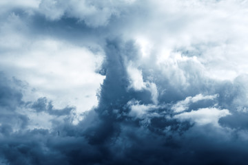 The image of the sky with thunderclouds, toning in dark blue color...