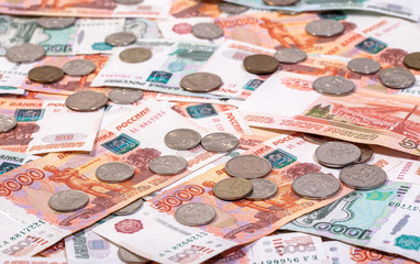 Background of banknotes of Russian rubles with the lotof coins