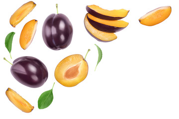 fresh purple plum and half with leaves isolated on white background with clipping path and full depth of field. Top view. Flat lay