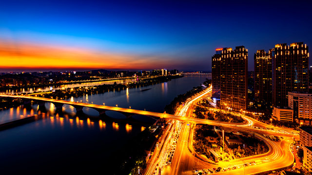 Illuminated Bridge Over Xiang River By Buildings At Dusk