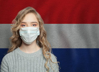 Young woman wearing a face mask with national croatian  flag. Flu epidemic and virus protection...