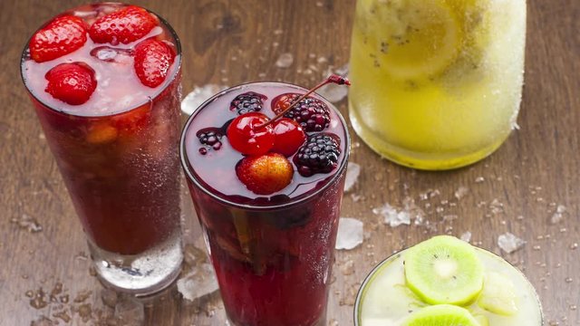 delicious cold drinks of colorful tropical fruits, strawberry, kiwi, cherries, lemon, passion fruit, raspberry