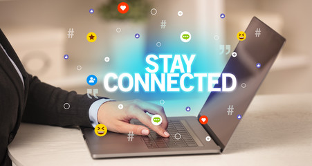 Freelance woman using laptop with STAY CONNECTED inscription, Social media concept