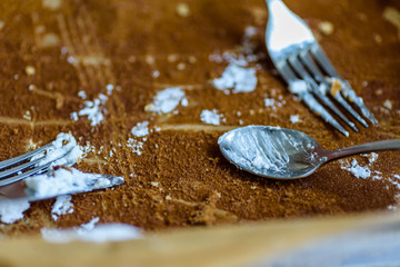 fork knife and spoon covered with apple pie icing on empty baking paper tray