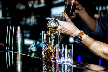 bartender pouring alcohol in a bar