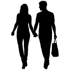 Silhouette man and woman walking hand in hand