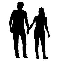 Silhouette man and woman walking hand in hand