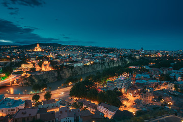 Tbilisi, Georgia. Evening Night View Of Georgian Capital Skyline. Scenic Top View Of Summer Evening Cityscape Of Tbilisi, Georgia In Illumination Lights With All Famous Landmarks, Sightseeings