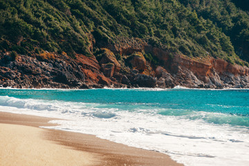 Beach of Cleopatra with blue sea and rocks of Alanya peninsula, Antalya, Turkey