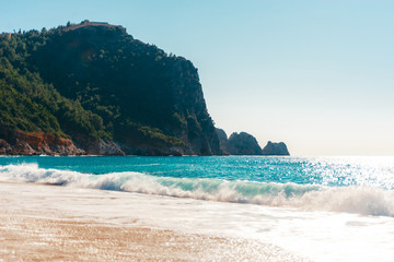 Beach of Cleopatra with blue sea and rocks of Alanya peninsula, Antalya, Turkey
