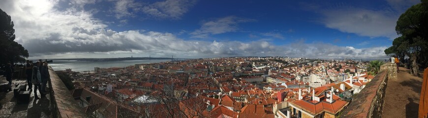 Fototapeta na wymiar Panoramic view from Castelo de S. Jorge in Lisbon. Sunny day, clear blue sky with some clouds.