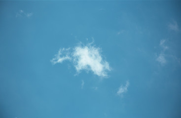 Fototapeta na wymiar Fluffy clouds cover the summer blue sky