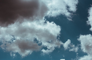 Fototapeta premium Fluffy clouds cover the summer blue sky