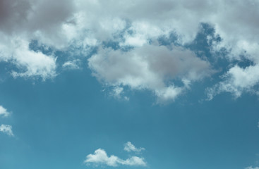 Fototapeta premium Fluffy clouds cover the summer blue sky