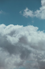 Obraz premium Fluffy clouds cover the summer blue sky