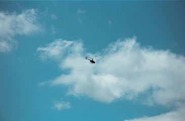 Fluffy clouds cover the summer blue sky