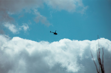 Fluffy clouds cover the summer blue sky