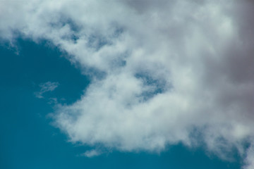 Obraz premium Fluffy clouds cover the summer blue sky