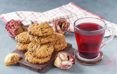 Oatmeal cookies with prunes next to pink tea and roses