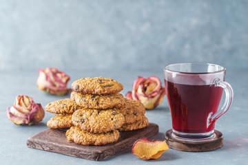 Oatmeal cookies with prunes next to pink tea and roses