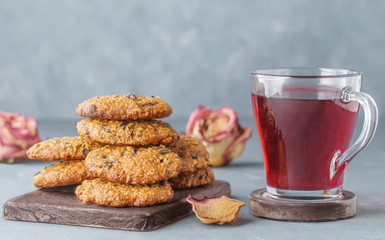 Oatmeal cookies with prunes next to pink tea and roses