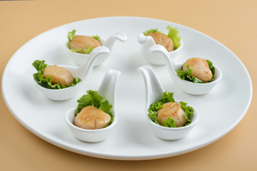 Scallop snack on spoon